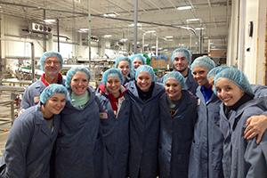 people in a group photo wearing coats and hairnets